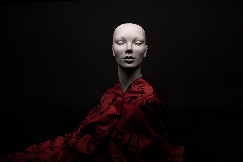 Studio portrait of mannequin styled in red fabric with dramatic lighting – photographed by wedding photographer Niko Coric – Lumen Clarity Media