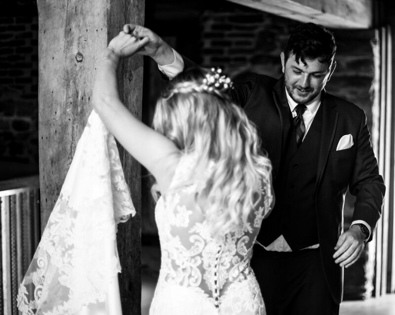 Groom twirls bride around during first look photos at Quincy Cellars