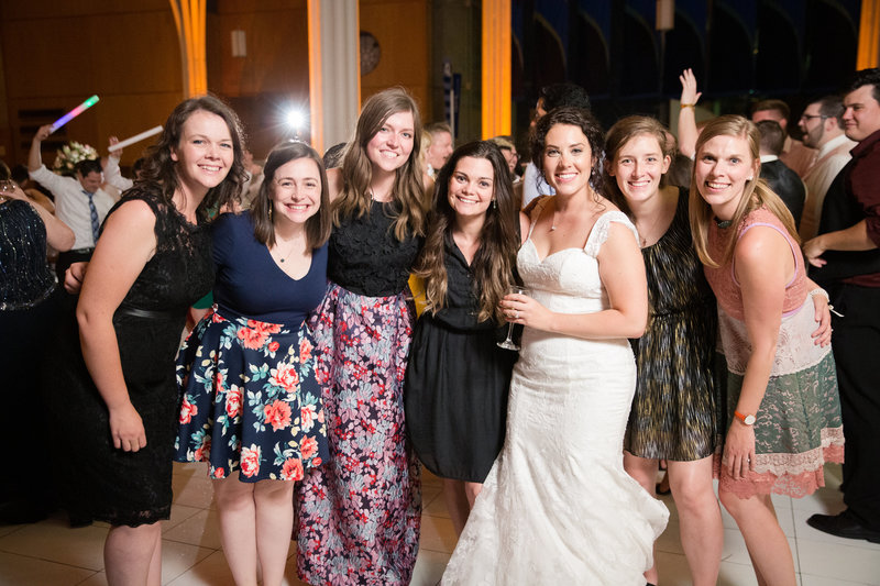This is a group of happy Evangeline Renee brides all gathered at a wedding.