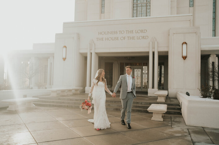 Bride and groom walking outside of an LDS temple on their wedding day