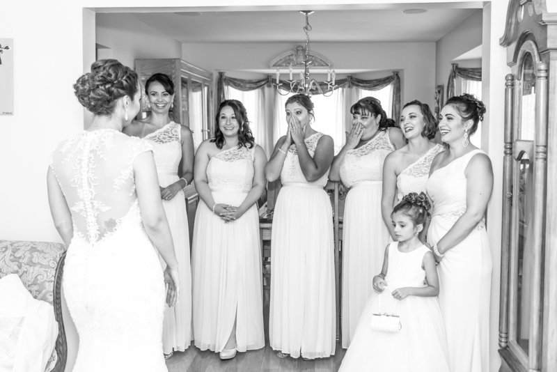 Bridemaids share a first look with the bride.