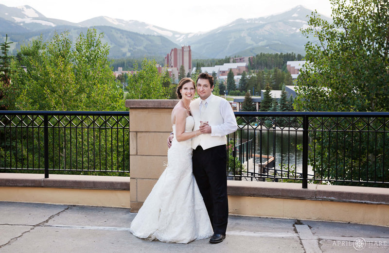 Wedding couple pose for a portrait on the outdoor patio at Main Street Station wedding reception in Breckenridge Colorado