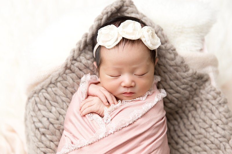 newborn with pink lace wrap