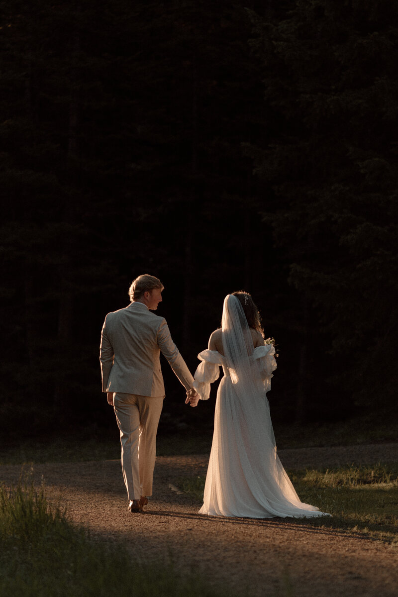 Bride and Groom walking in sunrise at hidden valley rocky mountain national park