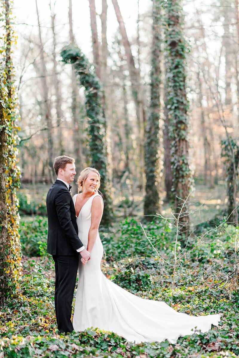 bride and groom standing in ivy by Knoxville Wedding Photographer, Amanda May Photos