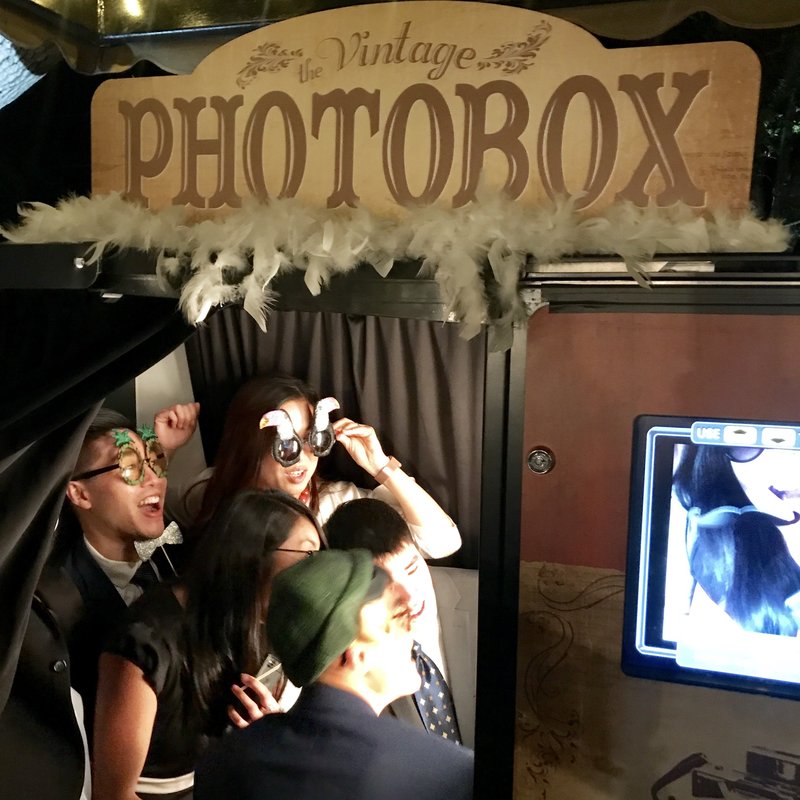 young adults having fun in classic photo booth