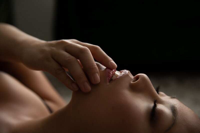 Close up of woman's face with hand by boudoir photographers nj
