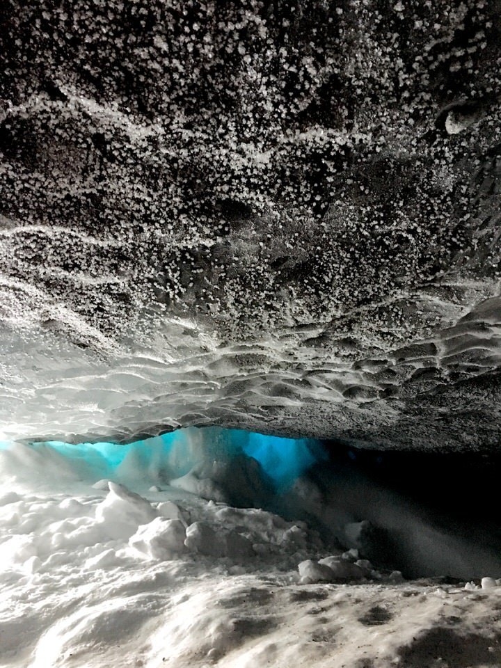 light peaking through a crack in a glacier
