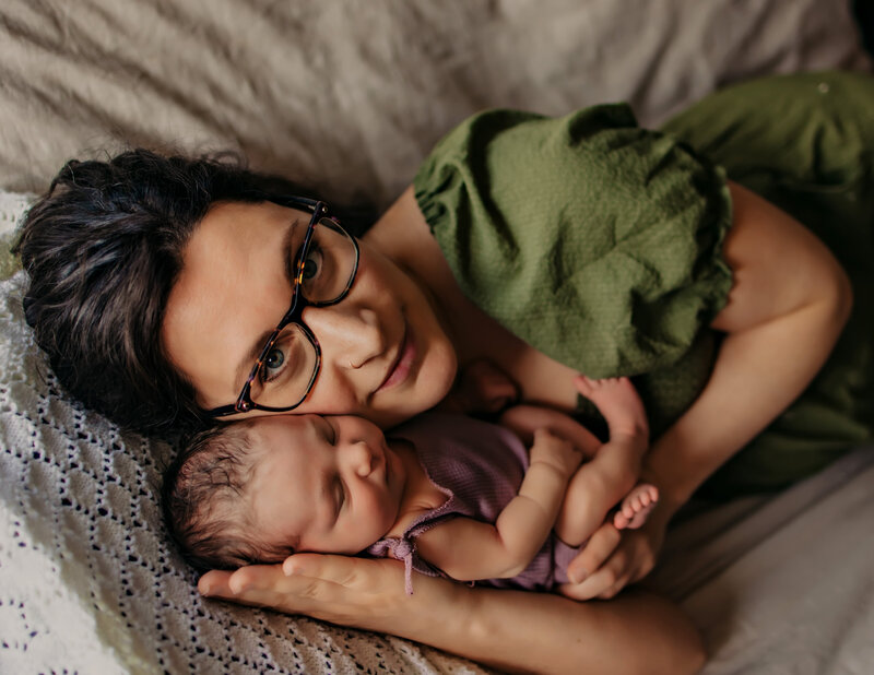 mom nurses newborn baby during photoshoot with Edmonton's best newborn photogrpapher