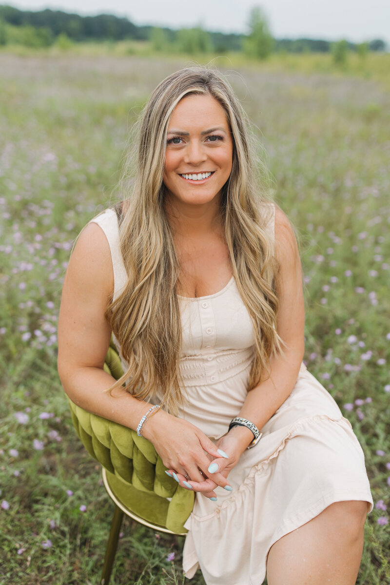 Woman sitting in a salon chair smiling