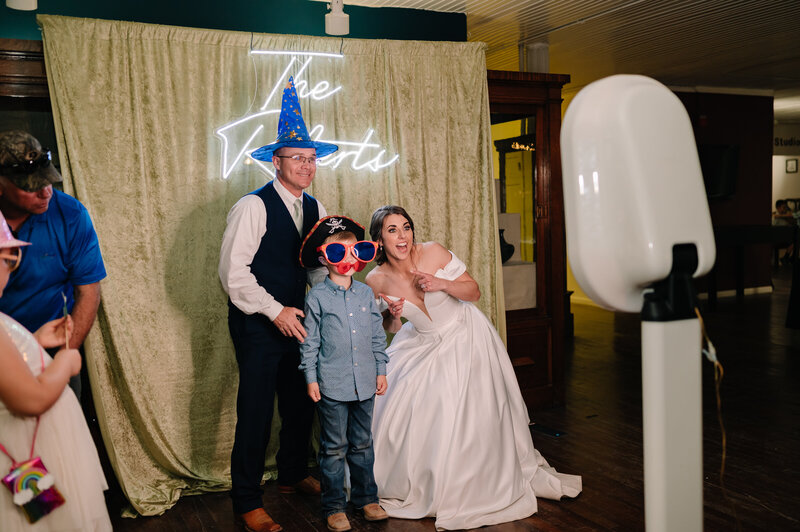 Bride and groom posing for a photo booth photo