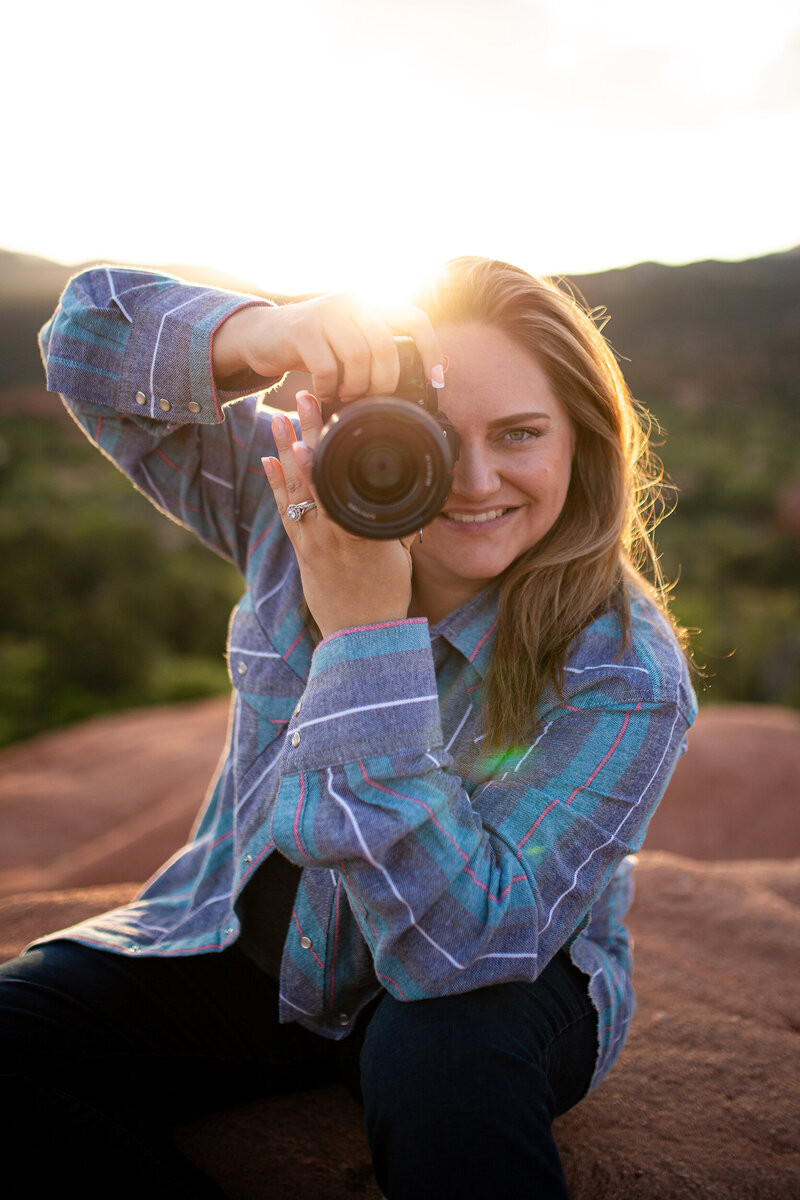 Colorado Springs wedding photographer smiling behind the camera during golden hour at Garden of the Gods.