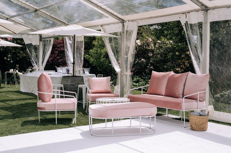 pink velvet couch and chairs and ottoman from little hire company in a clear marquee with other white furniture in merivale backyard