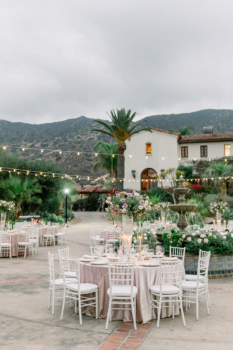 Outdoor wedding reception tables set beneath string lights at Hummingbird Nest Ranch in Simi Valley CA