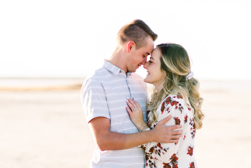 Cute  couple from Salt Lake City Utah at the Great Saltair for their engagement session snuggling close together and smiling at each other taken by Utah Wedding Photographer Andria Joleen Photography