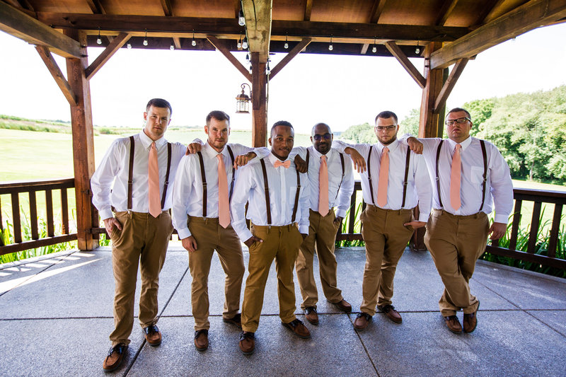 Groom poses with groomsmen at Betsy's Barn wedding