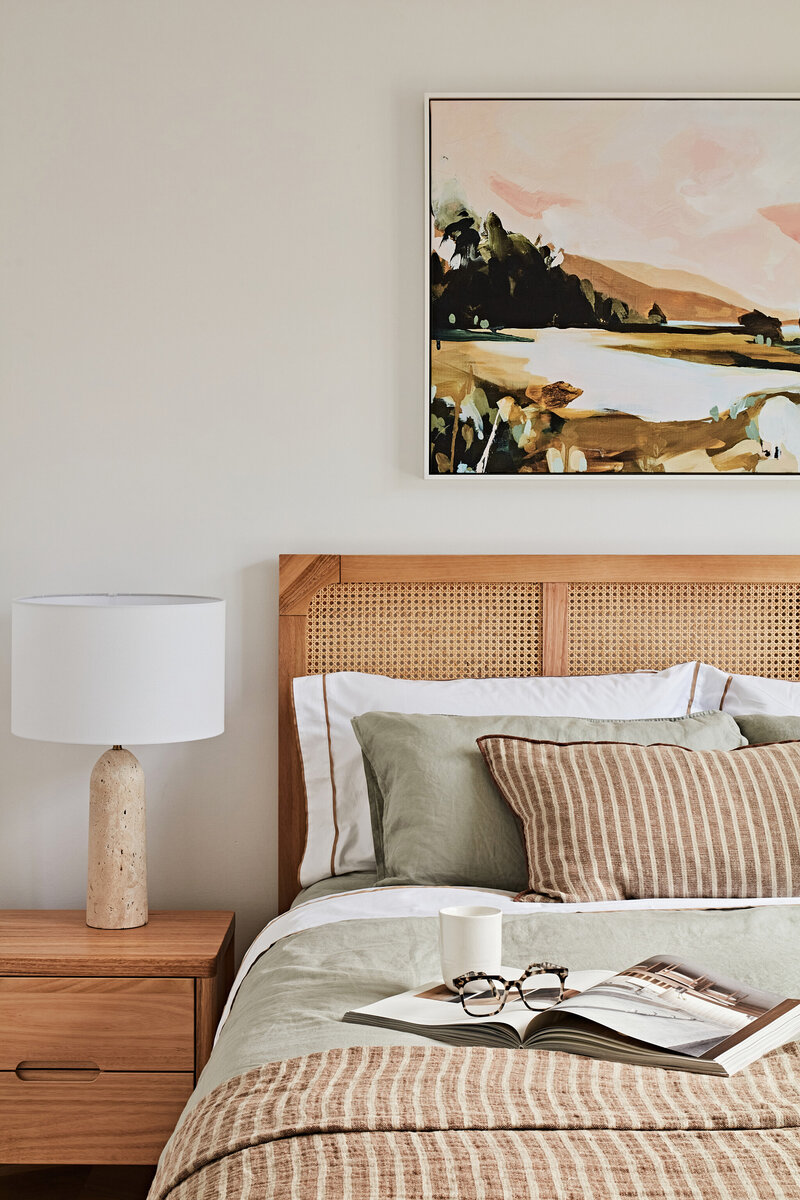 Modern bedroom interior with layered bedding and timber furniture styled by Lisa Hunter Interiors.