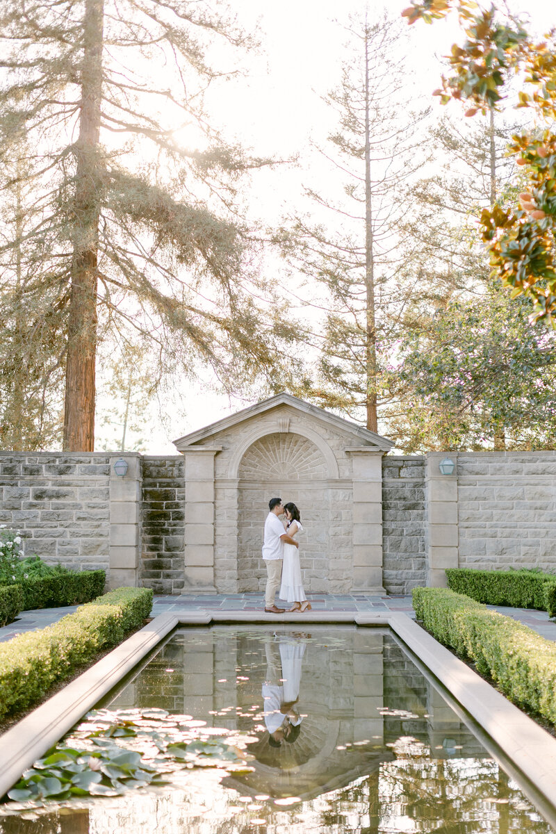 Man kisses his fiance's forehead during engagement photography session