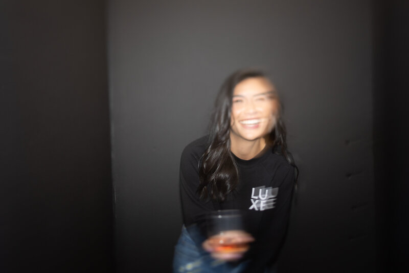 Asian-Amnerican woman laughing in motion blur photo