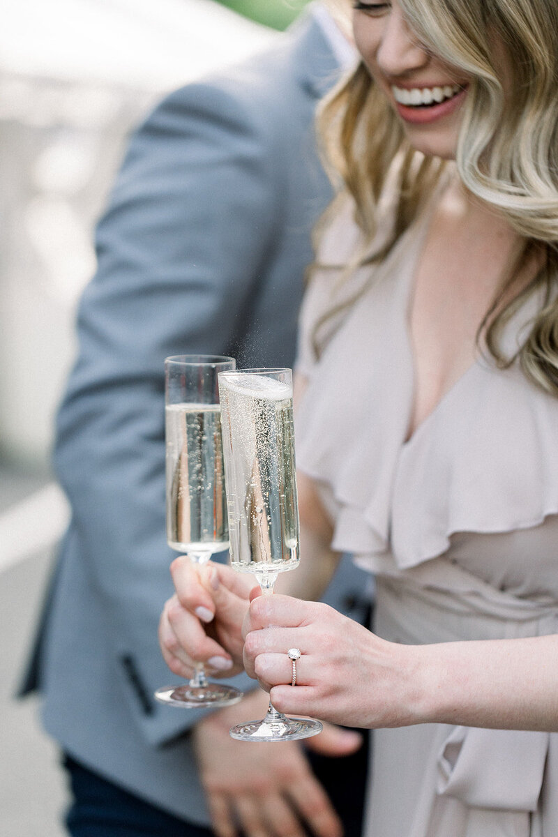 bride to be holding champagne glasses