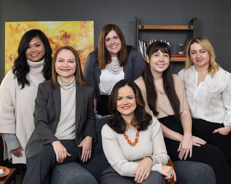 Professional team photo of a Toronto-based psychology clinic. Showcasing professional, warm friendly smiles