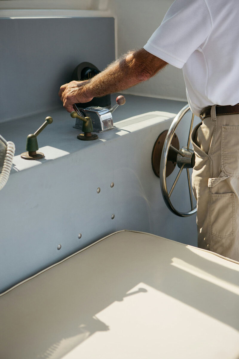 man holding shift while driving boat