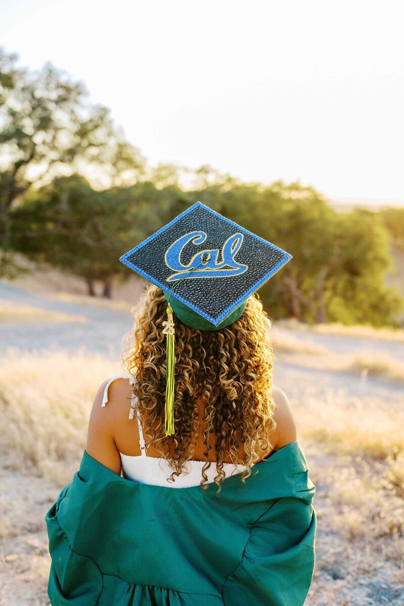 Black and white photo of a OPRF HS senior holding her cap