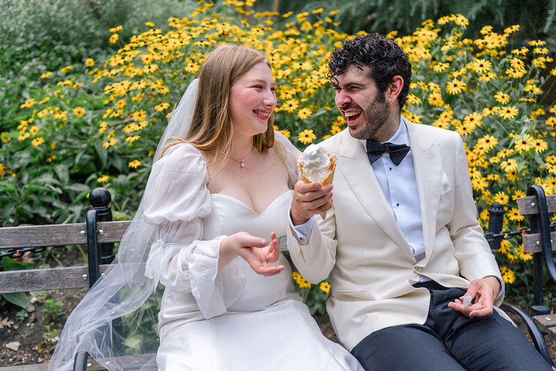 Editorial Photo of Jewish Couple in Chicago with ice cream and backed by bright yellow flowers in an elopement style jewish wedding