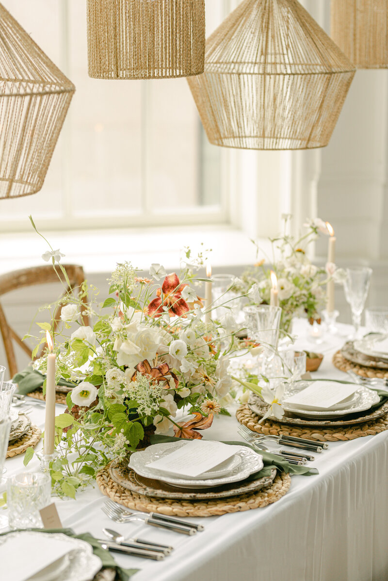 Lush Wedding Table Setting With Green and Peach Florals and Chandeliers