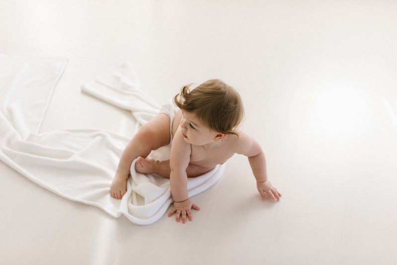 Baby girl in white Chicago studio, photo by Elle Baker Photography