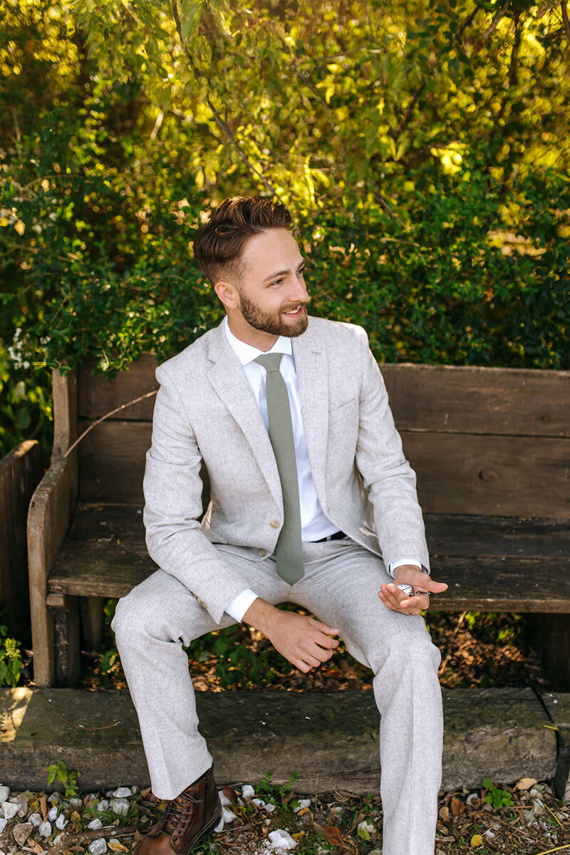 groom sitting on bench