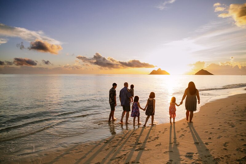 A family walks along the beach in Kailua.
