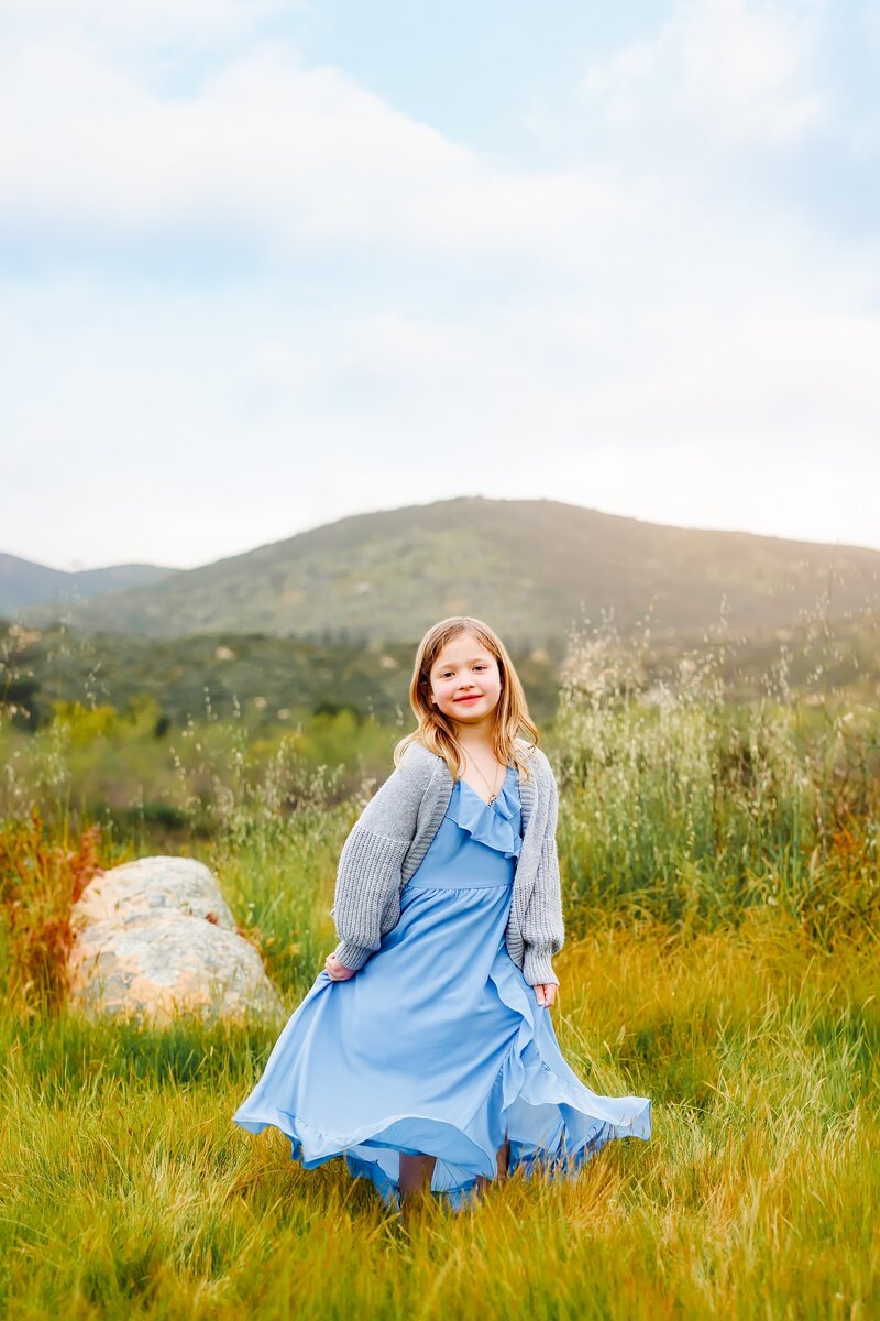 Portrait of a little girl standing in a field