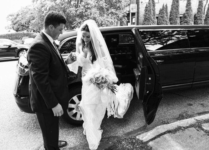 Groom helps bride out of limousine in Erie, PA