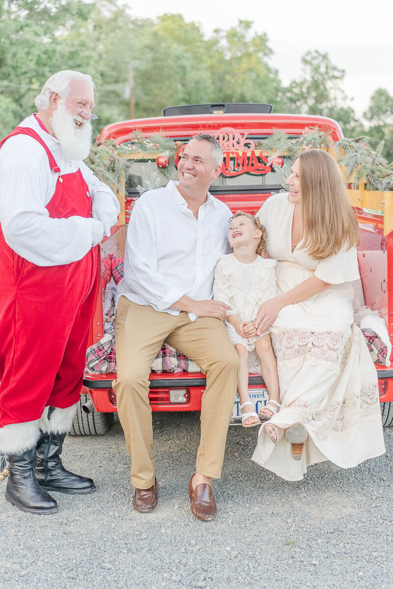 family laughing with Santa during Northern VA red truck minis
