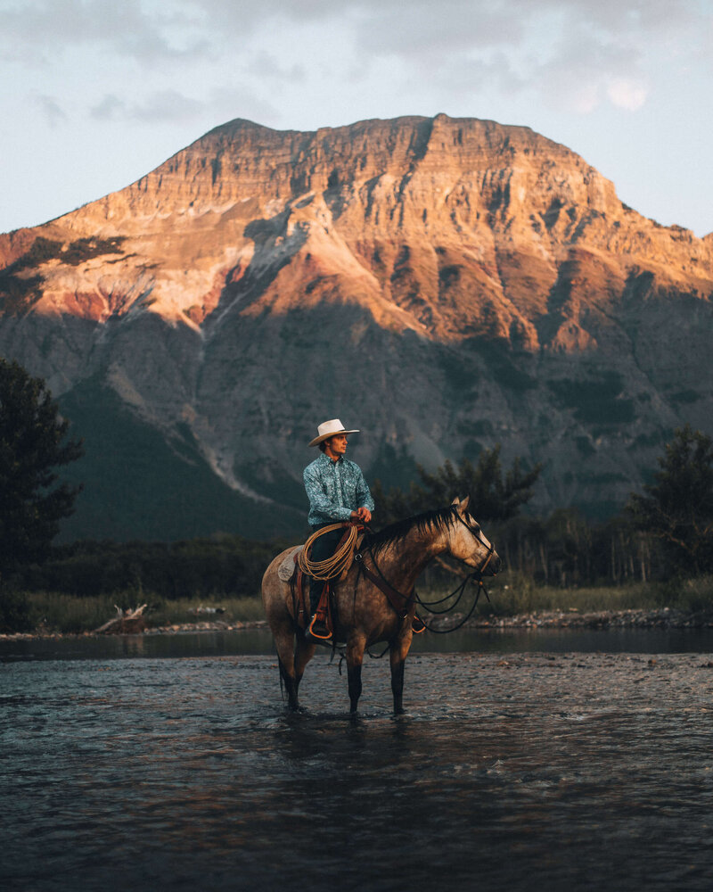 cowboy on horse in river