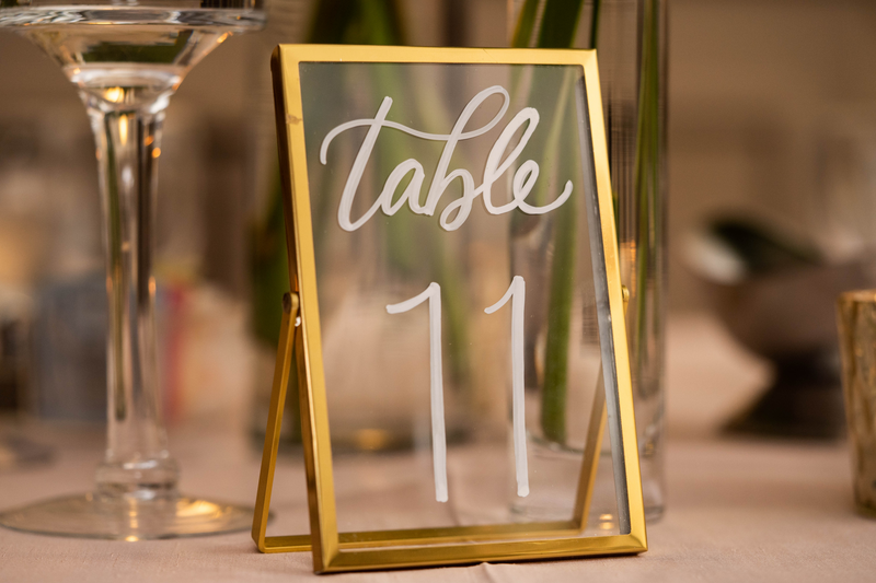 Close-up of a glass table card with Table 11 written in white