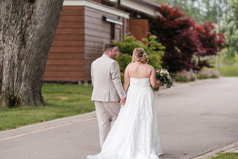 bride and groom walking together at barnwood events, a wedding venue in madison, winconsin.