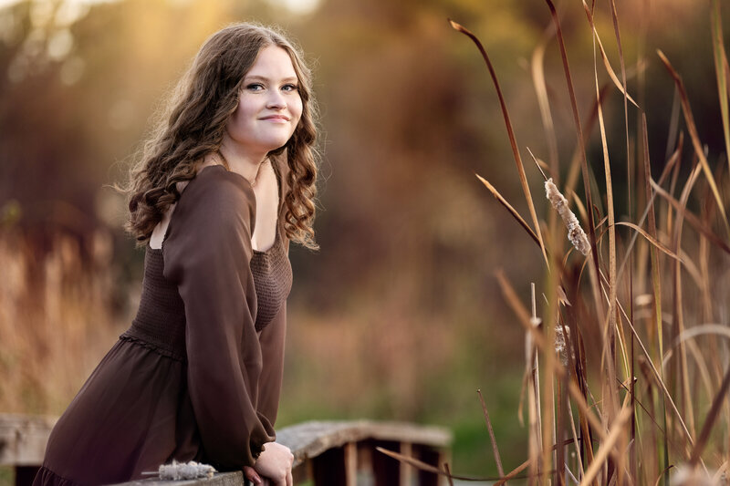 Minnetonka Minnesota high school senior photo of  girl in brown dress on old bridge in fall