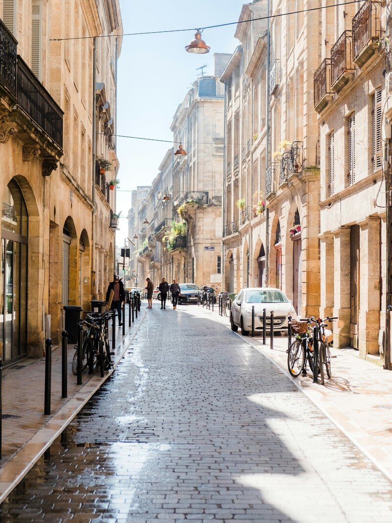 A picturesque street in Bordeaux, with cobbled streets and historic stone facades, reflecting the charm of Southwest France—just a five-minute stroll from Chateau Charente, perfectly placed between Bordeaux and Cognac for exploring the region's rich culture and beauty.