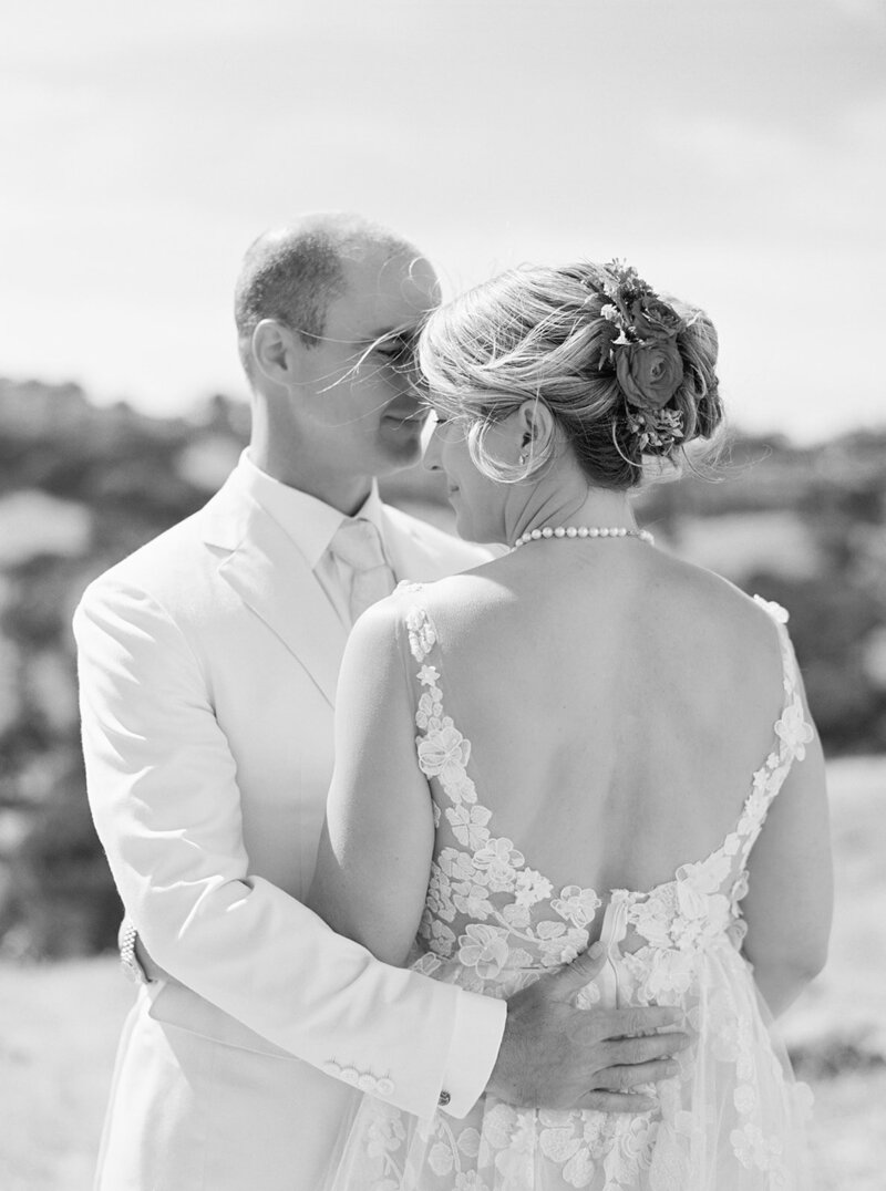 Intimate black and white image of bride and groom embracing during their Bay Area wedding, captured on film with a fine art documentary aesthetic.