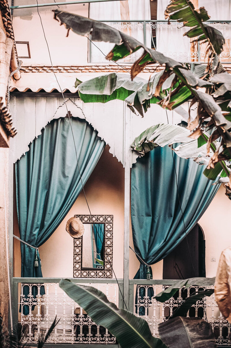 Luxury Hideaway Vacation with Peach Hotel, Terracotta shingles, and teal outdoor curtains