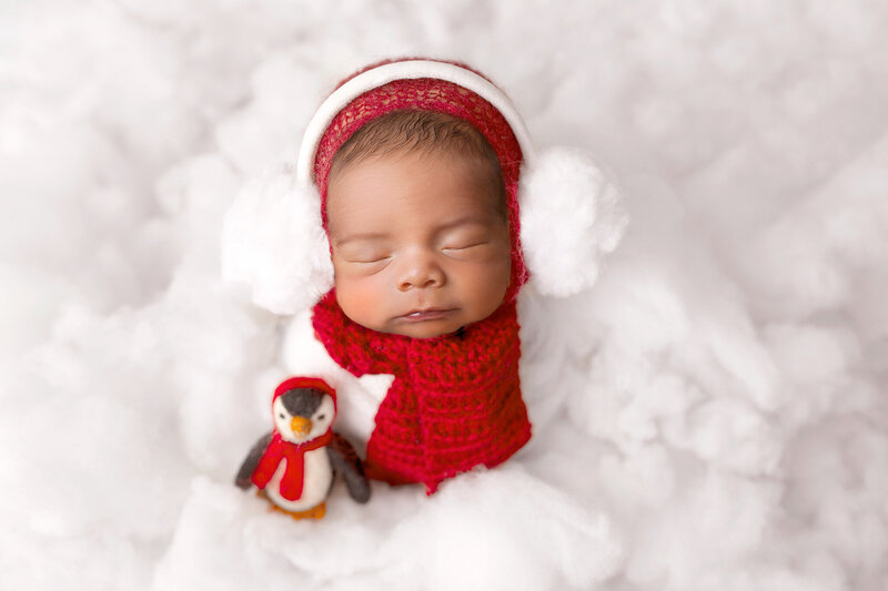 Newborn posing in white fluffy snow