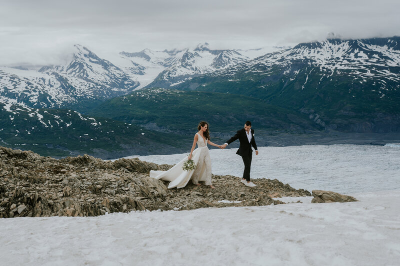 bride and groom on water edge