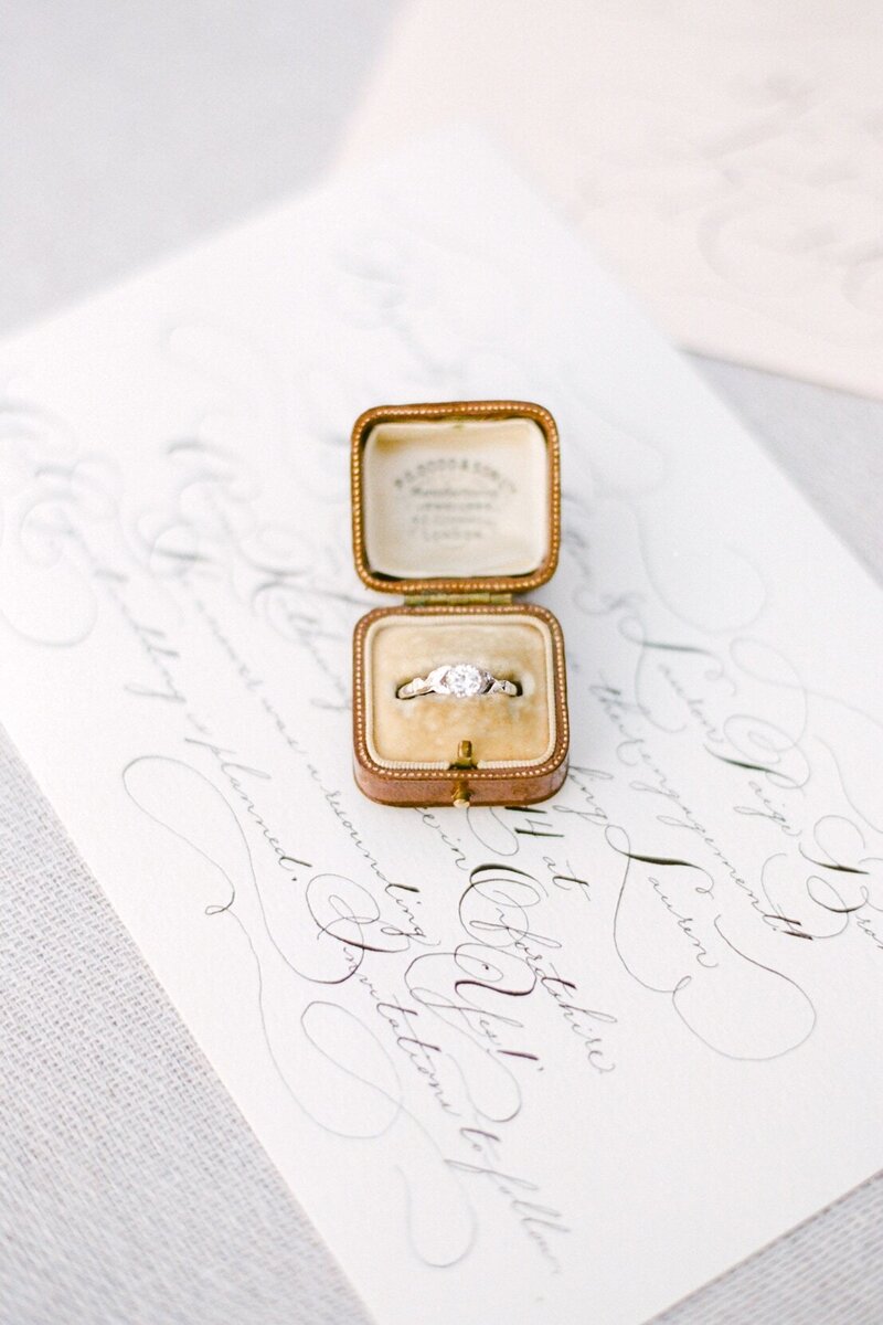 vintage leather ring box on a calligraphy proposal