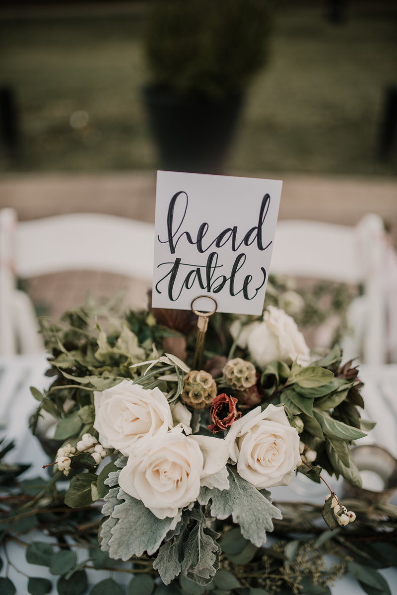 Head table arrangement for bride and groom at The Inn at Carnall Hall , Fayetteville, AR reception