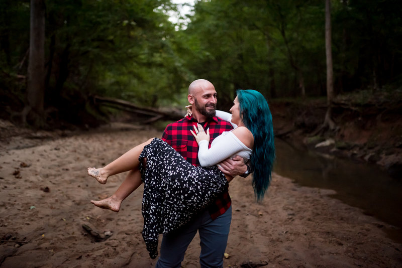 guy-carries-fiance-engagement-photographer