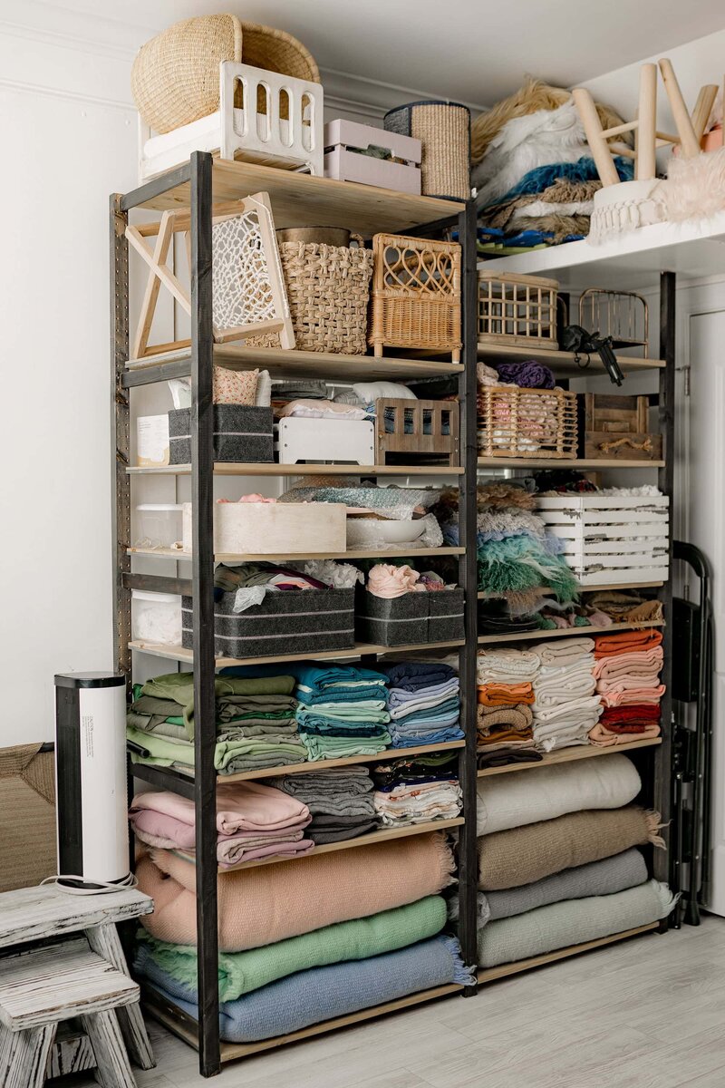 shelving full of newborn drops and props