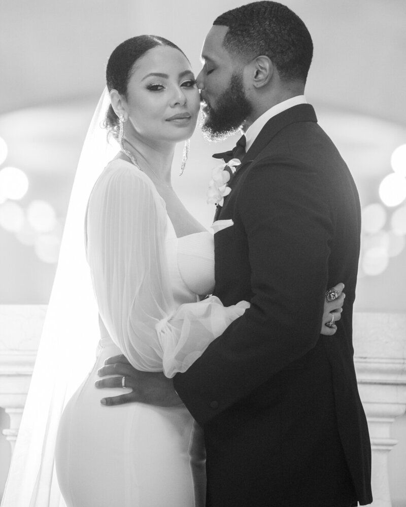 a bride and groom embracing in black and white
