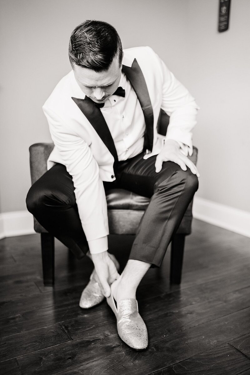 groom putting on shoes by Knoxville Wedding Photographer, Amanda May Photos